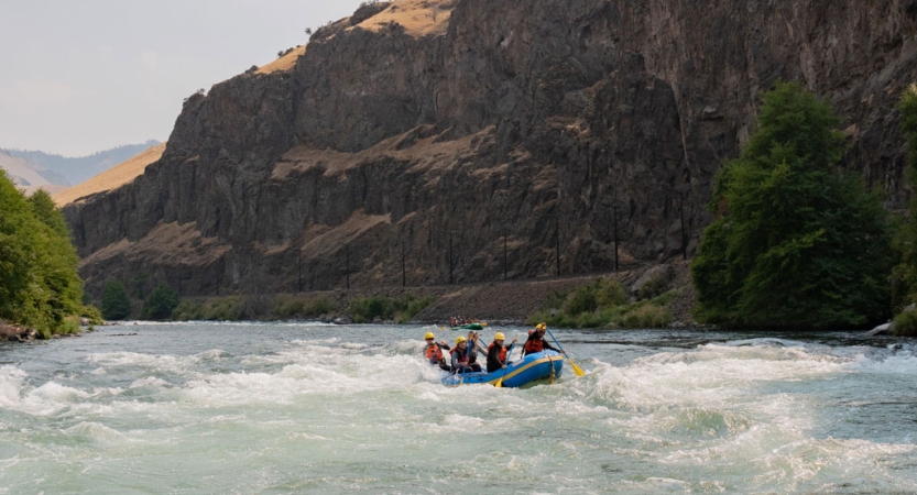 A group of students navigate a raft on the Deschutes River in Oregon. 